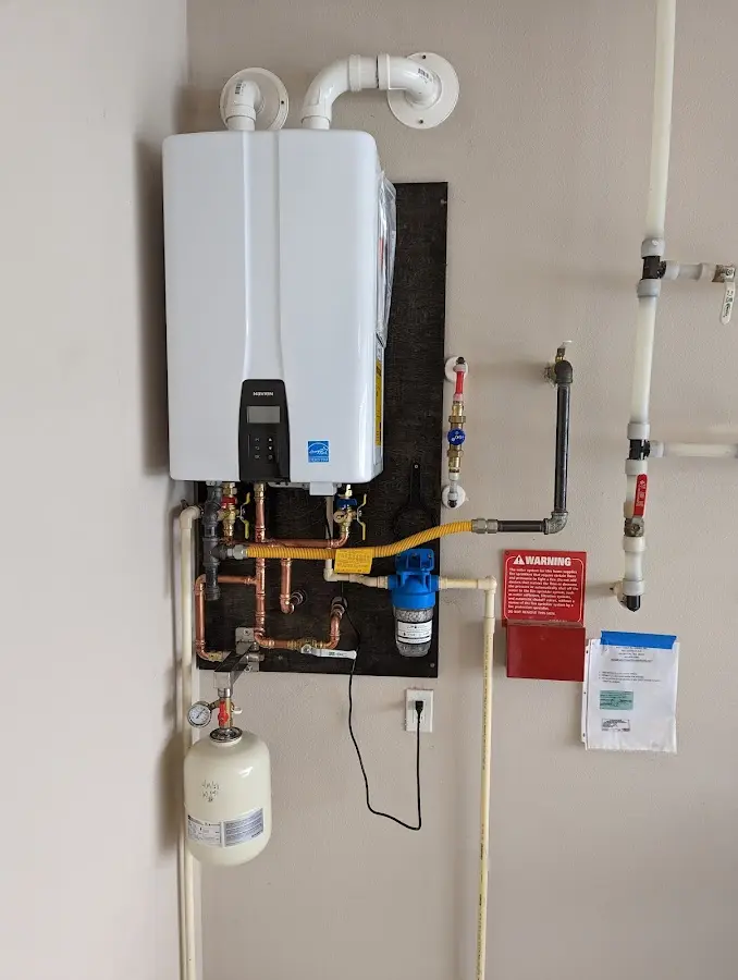 Professional plumber installing copper piping in a Mathis home